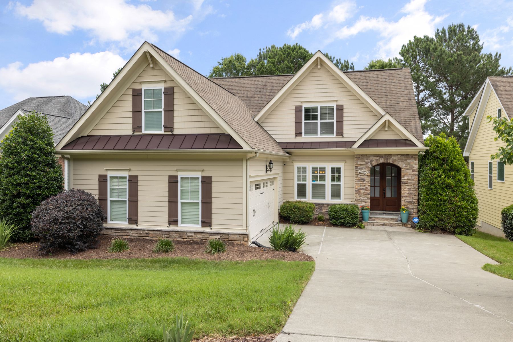 Suburban house with a manicured lawn and planted garden beds